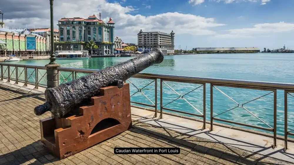Port Louis waterfront promenade with cannon and harbor view